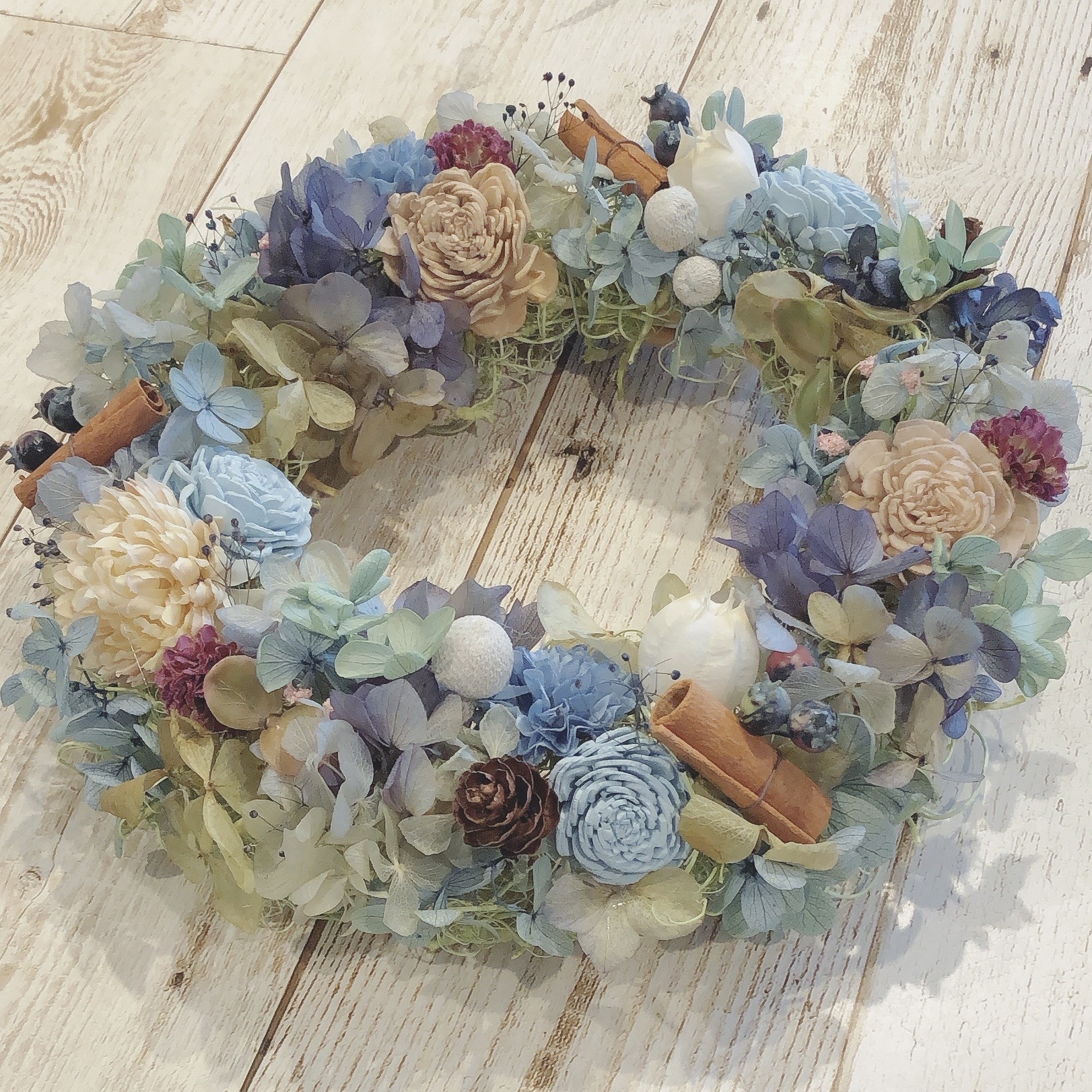 ブルーと白のお花や木の実を組み合わせたフラワーリース